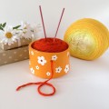 Small orange crochet yarn holder bowl with retro daisy flowers Knitter gifts