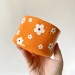 Small orange crochet yarn holder bowl with retro daisy flowers Knitter gifts