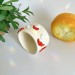 Small milky crochet yarn bowl with amanita mushrooms