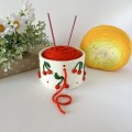 Small milky white crochet yarn holder bowl with red cherries and dots Knitters crocheters