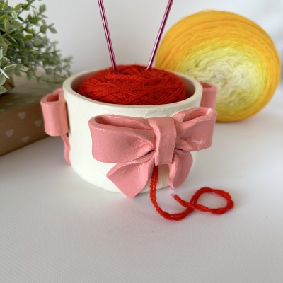 Small milky white crochet yarn holder bowl with pink coquette bows Knitters crocheters