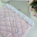 Soft pink laptop sleeve with ruffles, bows and pearl-like beads