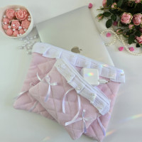 Soft pink laptop sleeve with ruffles, bows and pearl-like beads