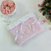 Soft pink E-reader sleeve with ruffles, bows and pearl-like beads