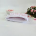 Soft pink E-reader sleeve with ruffles, bows and pearl-like beads