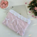 Soft pink tablet sleeve with ruffles, bows and pearl-like beads