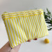 Yellow striped tablet sleeve with ruffles