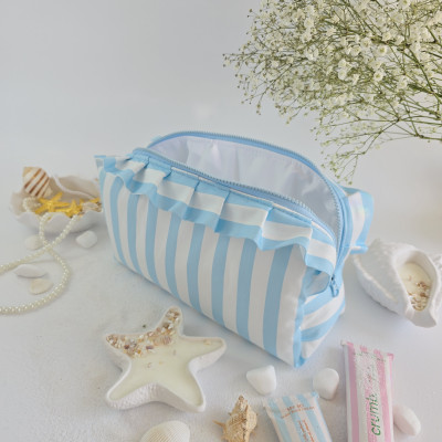 Large sky-blue striped cosmetic bag with ruffles