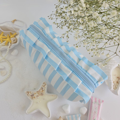Large sky-blue striped cosmetic bag with ruffles