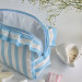 Large sky-blue striped cosmetic bag with ruffles