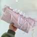 Large soft pink cosmetic bag with ruffles, bows and pearl-like beads