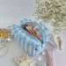 Medium sky-blue striped cosmetic bag with ruffles