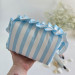 Medium sky-blue striped cosmetic bag with ruffles