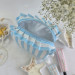 Medium sky-blue striped cosmetic bag with ruffles