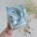 Medium sky-blue striped cosmetic bag with ruffles