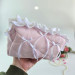 Medium soft pink cosmetic bag with ruffles, bows and pearl-like beads