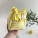 Medium yellow striped cosmetic bag with ruffles