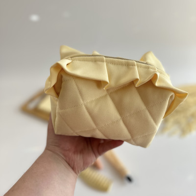Small butter yellow cosmetic bag with ruffles