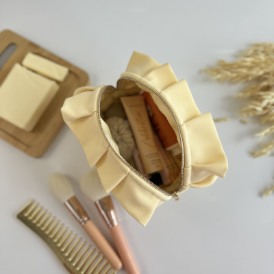 Small butter yellow cosmetic bag with ruffles