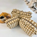 Small checkered brown cosmetic bag with ruffles