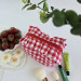 Small red gingham cosmetic bag with ruffles