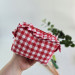 Small red gingham cosmetic bag with ruffles