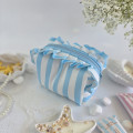Small sky-blue striped cosmetic bag with ruffles