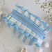 Small sky-blue striped cosmetic bag with ruffles