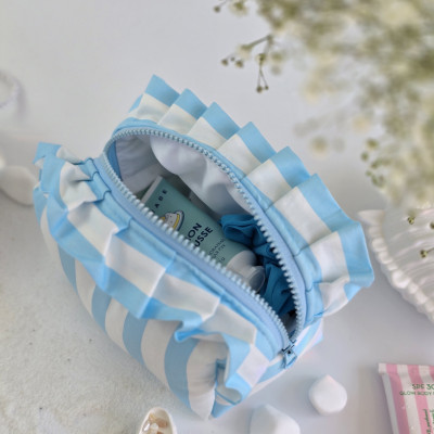 Small sky-blue striped cosmetic bag with ruffles