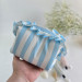Small sky-blue striped cosmetic bag with ruffles