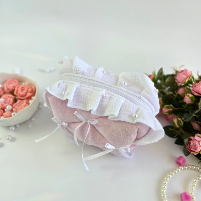 Small soft pink cosmetic bag with ruffles, bows and pearl-like beads