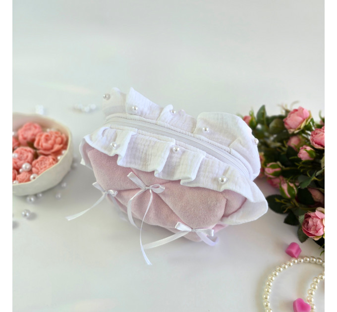 Small soft pink cosmetic bag with ruffles, bows and pearl-like beads