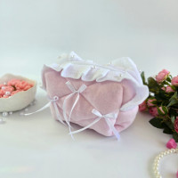 Small soft pink cosmetic bag with ruffles, bows and pearl-like beads