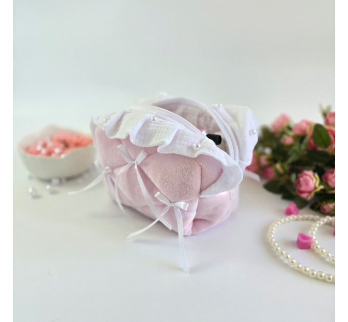 Small soft pink cosmetic bag with ruffles, bows and pearl-like beads