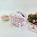 Small soft pink cosmetic bag with ruffles, bows and pearl-like beads