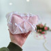 Small soft pink cosmetic bag with ruffles, bows and pearl-like beads