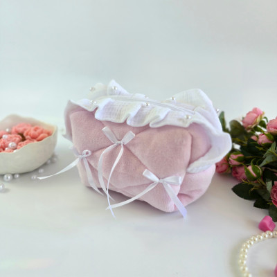 Small soft pink cosmetic bag with ruffles, bows and pearl-like beads