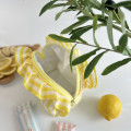 Small yellow striped cosmetic bag with ruffles