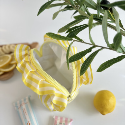 Small yellow striped cosmetic bag with ruffles
