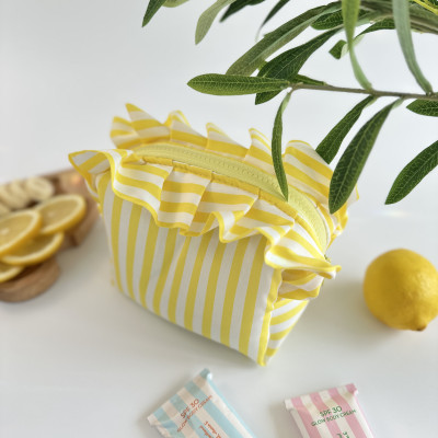 Small yellow striped cosmetic bag with ruffles
