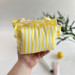 Small yellow striped cosmetic bag with ruffles
